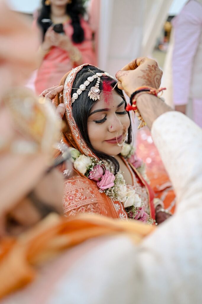 pexels-photo-30184615-30184615 Bride receiving sindoor in a vibrant Indian wedding ceremony.